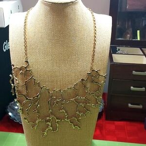 Gold tone coral bib necklace.